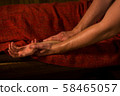 Masseur doing hand massage for female client 58465057