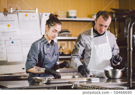 Cheerful Experienced Man And Woman Staff. Profession preparation confectionery products. Caucasian Cheerful Experienced Man And Woman Staff. Profession preparation confectionery products. Caucasian 58466680