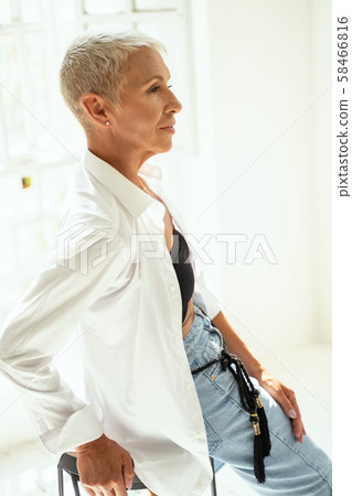 Attractive senior female person sitting in semi position Attractive senior female person sitting in semi position 58466816