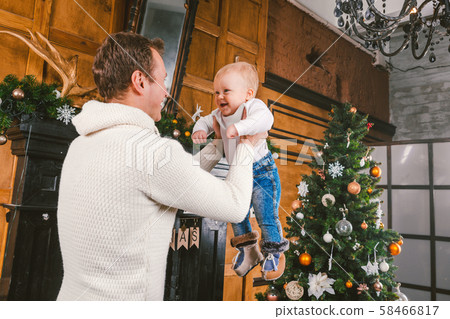 Man and cute baby are ready to celebrate new year. Happy Father And child son Near Christmas Tree 58466817