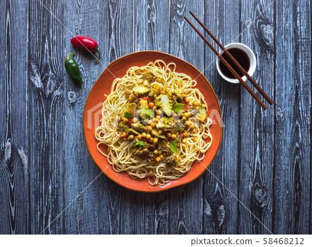 Roasted romanesco curry with nuts and pasta.   58468212