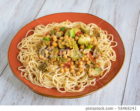 Roasted romanesco curry with nuts and pasta.   58468241