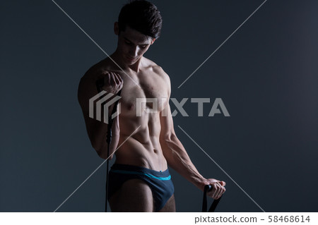 Muscular fitness young male antique perfect muscles six packs of abs and bare chest. Bodybuilder 58468614