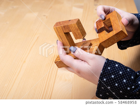 Girl with puzzle details oblique knot. Dark manicure on nails. Girl with puzzle details oblique knot. Dark manicure on nails. 58468958