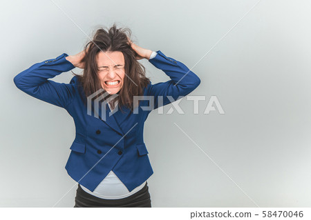 Young teacher bearing fingers in her hair, making in tousled, screaming, setting her teeth, closing Young teacher bearing fingers in her hair, making in tousled, screaming, setting her teeth, closing 58470046