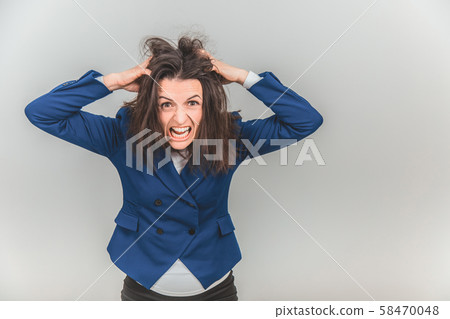 Young teacher bearing fingers in her hair, making in tousled, screaming, looking out of mind. Young teacher bearing fingers in her hair, making in tousled, screaming, looking out of mind. 58470048