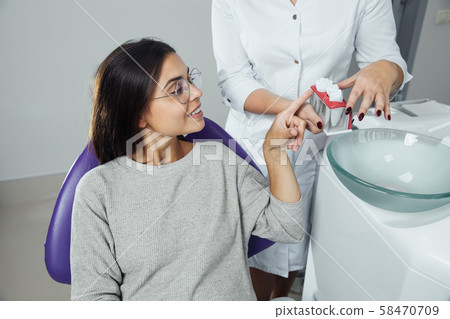 A woman is preparing for a dental examination. Woman having teeth examined at dentists. A woman is preparing for a dental examination. Woman having teeth examined at dentists. 58470709