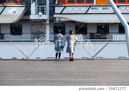 Two women seeing off a luxury liner 58471277