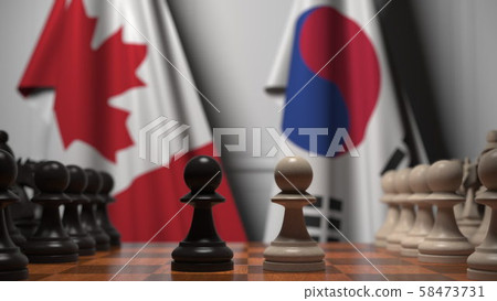 Chess game against flags of Canada and Korea. Political competition related 3D rendering 58473731