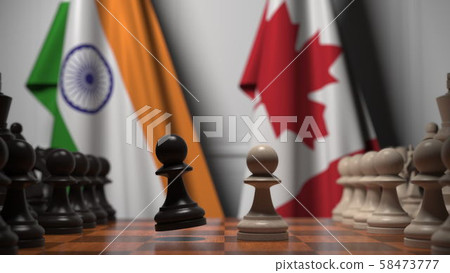 Chess game against flags of India and Canada. Political competition related 3D rendering Chess game against flags of India and Canada. Political competition related 3D rendering 58473777