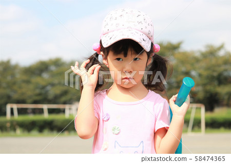 Girls playing in the park 58474365