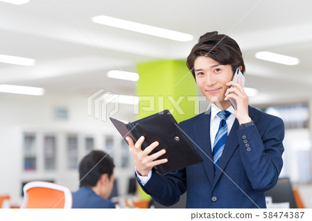 Businessman, office, suit, smartphone 58474387
