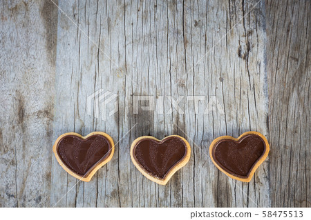 Chocolate heart on wooden background for gift in Valentine's day love. Select focus and Copy space background Chocolate heart on wooden background for gift in Valentine's day love. Select focus and Copy space background 58475513