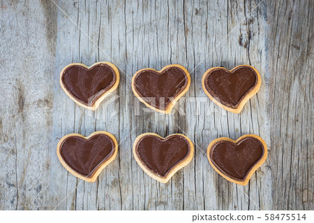 Chocolate heart on wooden background for gift in Valentine's day love. Select focus and Copy space background Chocolate heart on wooden background for gift in Valentine's day love. Select focus and Copy space background 58475514