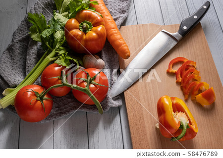 fresh vegetables on a light kitchen table. sliced fresh vegetables on a light kitchen table. sliced 58476789