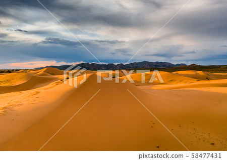 Storm clouds over sand dunes in the desert Storm clouds over sand dunes in the desert 58477431