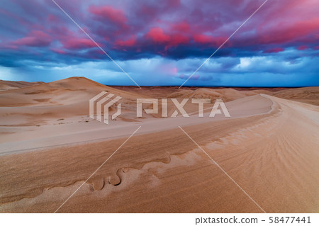 Dramatic sunset over sand dunes in the desert 58477441