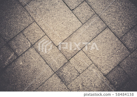 The sidewalk road from a natural stone is laid out by a mosaic of gray color .Texture.Background. The sidewalk road from a natural stone is laid out by a mosaic of gray color .Texture.Background. 58484138