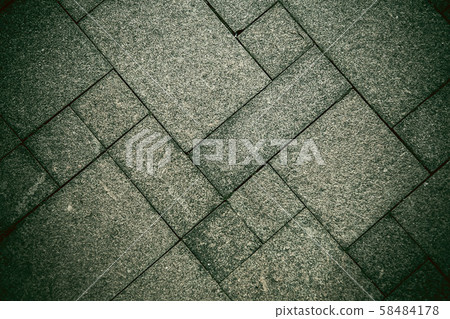The sidewalk road made of natural stone is lined with mosaics of gray green color .Background. The sidewalk road made of natural stone is lined with mosaics of gray green color .Background. 58484178