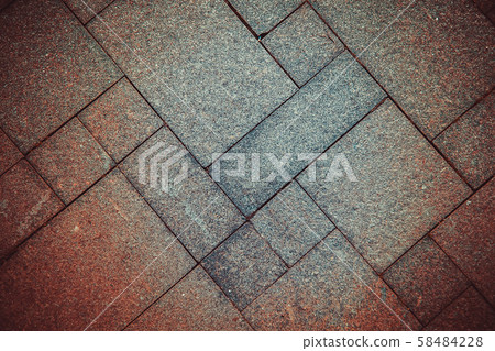 The sidewalk road made of natural stone is lined with mosaics of different colors The sidewalk road made of natural stone is lined with mosaics of different colors 58484228