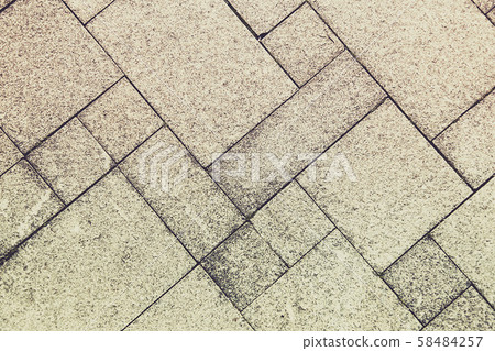 The sidewalk road made of natural stone is lined with mosaics of light gray color The sidewalk road made of natural stone is lined with mosaics of light gray color 58484257