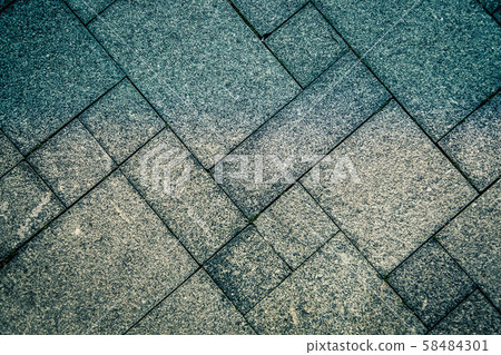 The sidewalk road from a natural stone is laid out by a mosaic of gray color .Texture. 58484301