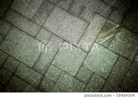 The sidewalk road made of natural stone is lined with mosaics of gray green color . The sidewalk road made of natural stone is lined with mosaics of gray green color . 58484304