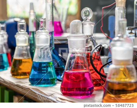 Test tubes with a colored reagents in a rack Test tubes with a colored reagents in a rack 58487723