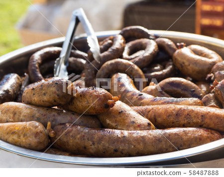 Grilled boar sausages on a large platter 58487888