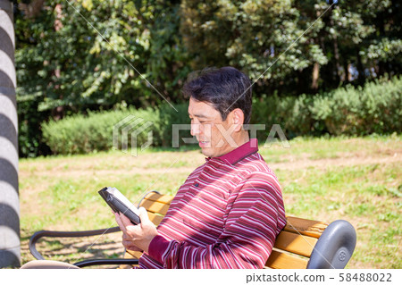 Reading in a sunny park 58488022