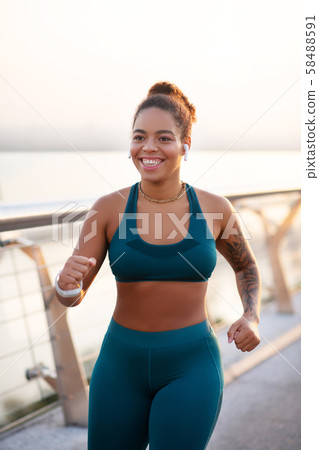 Beaming woman working on weight loss running fast Beaming woman working on weight loss running fast 58488591