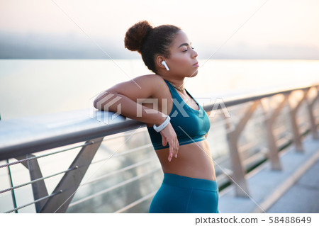 Woman enjoying the city view while standing on bridge 58488649