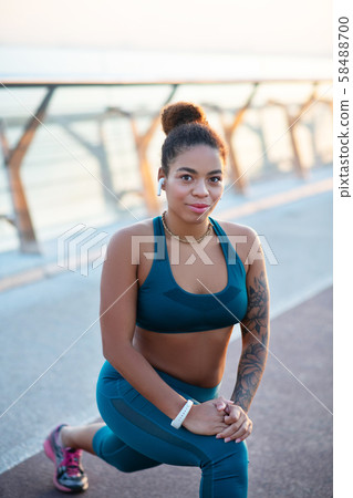 Dark-eyed woman feeling good while working out outside 58488700