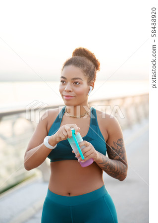 Woman drinking some water after intensive run Woman drinking some water after intensive run 58488920