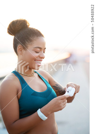 Woman smiling broadly feeling excited before workout 58488922