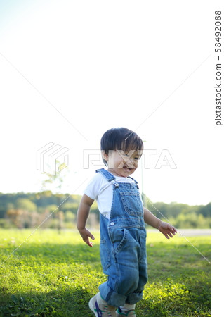 Two-year old boy playing in the park 58492088