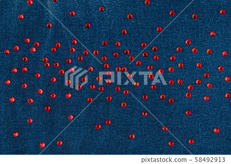 Fashion background with red rhinestones on denim. Fashion background with red rhinestones on denim. 58492913