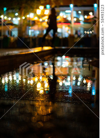 Bokeh backlight girl silhouette after rain on the street at night Bokeh backlight girl silhouette after rain on the street at night 58493123