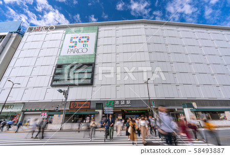 Tokyo cityscape in Japan On the pedestrian crossing, there are people with dangerous walking smartphones, but those who push bicycles also = JR Ikebukuro Station 58493887