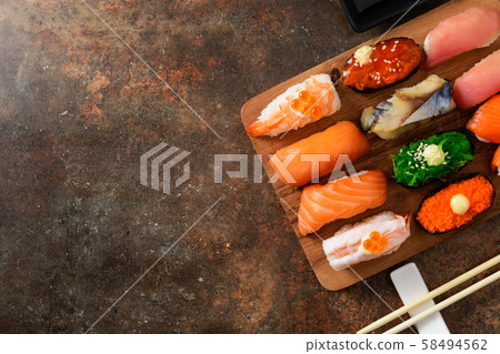 close up of sashimi sushi set with chopsticks 58494562