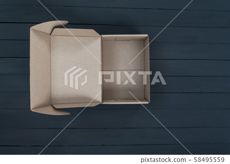 Empty open cardboard box on black wooden Empty open cardboard box on black wooden 58495559