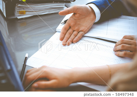 Bookkeeper or financial inspector and secretary making report, calculating or checking balance Bookkeeper or financial inspector and secretary making report, calculating or checking balance 58497348