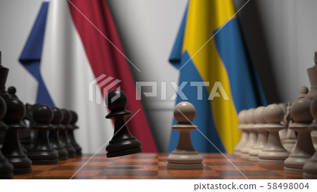 Flags of Netherlands and Sweden behind pawns on the chessboard. Chess game or political rivalry Flags of Netherlands and Sweden behind pawns on the chessboard. Chess game or political rivalry 58498004