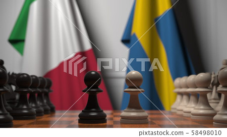 Flags of Italy and Sweden behind pawns on the chessboard. Chess game or political rivalry related 3D Flags of Italy and Sweden behind pawns on the chessboard. Chess game or political rivalry related 3D 58498010