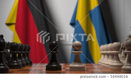 Flags of Germany and Sweden behind pawns on the chessboard. Chess game or political rivalry related 58498016