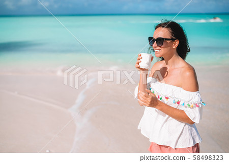 Young woman with cup of hot coffee enjoy holidays Young woman with cup of hot coffee enjoy holidays 58498323