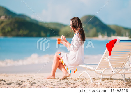 Young woman with tasty cocktail on summer vacation Young woman with tasty cocktail on summer vacation 58498328