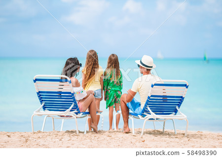 Happy family on a beach during summer vacation Happy family on a beach during summer vacation 58498390