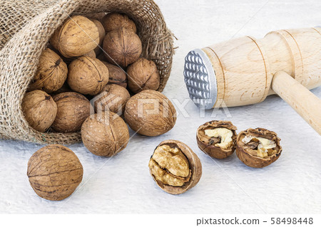 Small burlap bag with natural unbleached walnuts 58498448