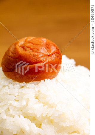 There is one pickled plum (seasoned plum dried and honey flavored) on top of the mountain rice. There is one pickled plum (seasoned plum dried and honey flavored) on top of the mountain rice. 58499072